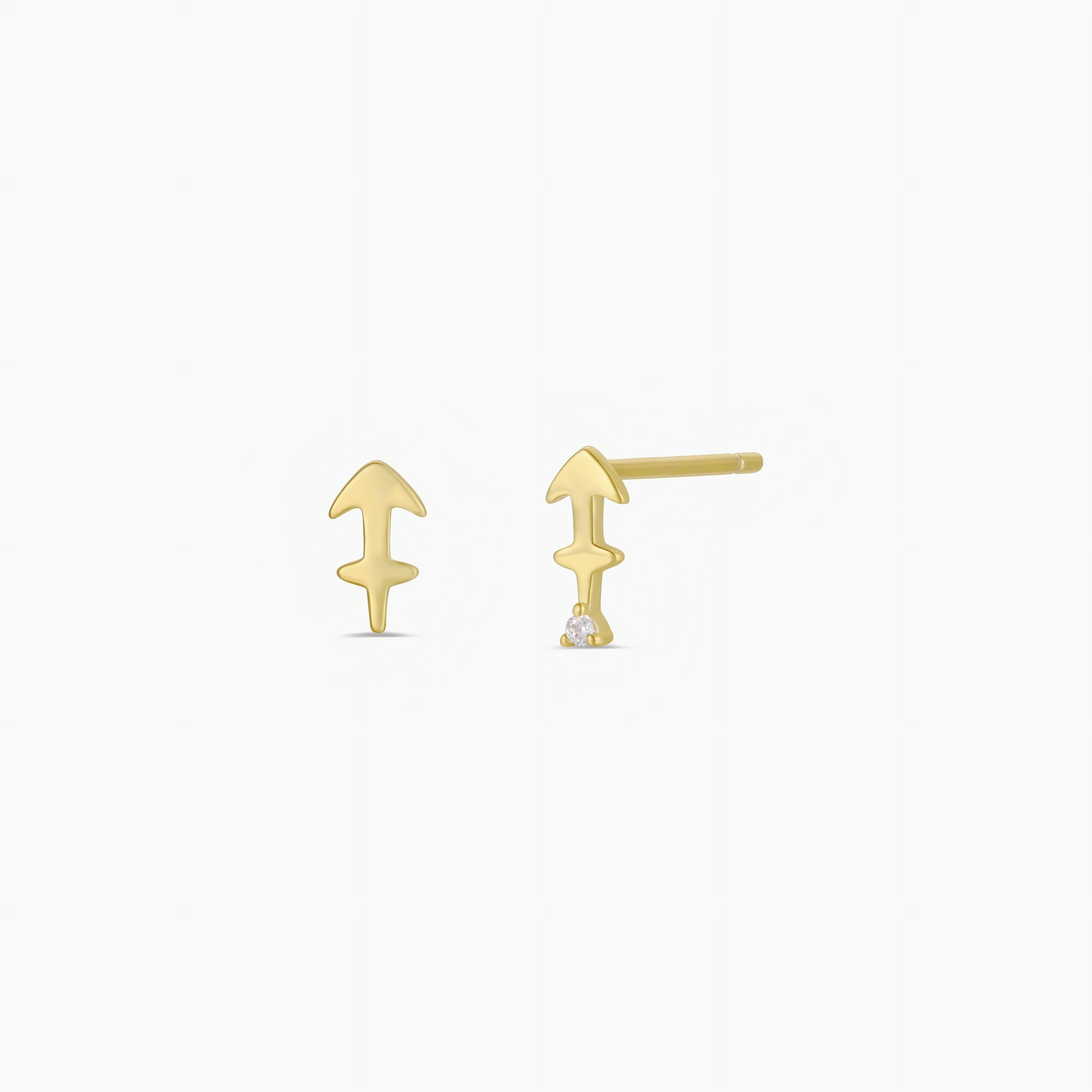 The Zodiac Earrings - Sagittarius are 18k gold-plated arrow-shaped studs with a small round gemstone at the tip, shown on a plain white background.