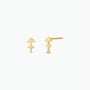 The Zodiac Earrings - Sagittarius are 18k gold-plated arrow-shaped studs with a small round gemstone at the tip, shown on a plain white background.