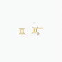 The Zodiac Earrings - Gemini feature a minimalist Gemini symbol in 18k gold plating with a clear gemstone at the base, subtly shining against a plain white background.