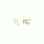 A pair of 18k Gold Plated Virgo Zodiac Earrings, one featuring a small clear gemstone accent. These charm studs are set against a plain, light-colored background.