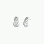 The Silver Bold Swirl - Earring features a ribbed, twisted sterling silver design. Shown from the front and side, these curved earrings have a textured finish with stud-style backs, giving a modern hoop-inspired look.