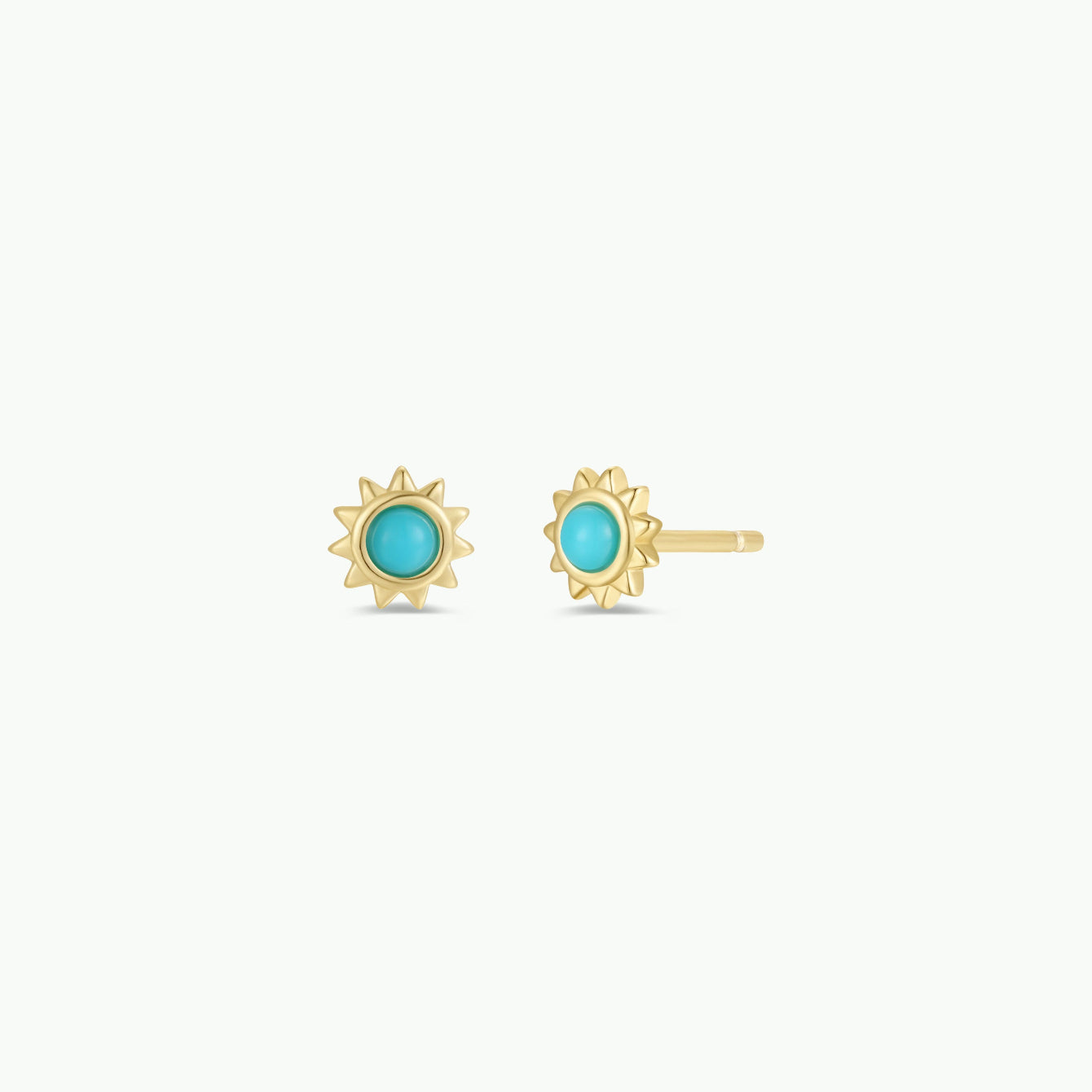 The Turquoise Sun Stud earrings feature sunburst-shaped gold studs, each with a round turquoise center and 18k gold plating, shown against a white background.