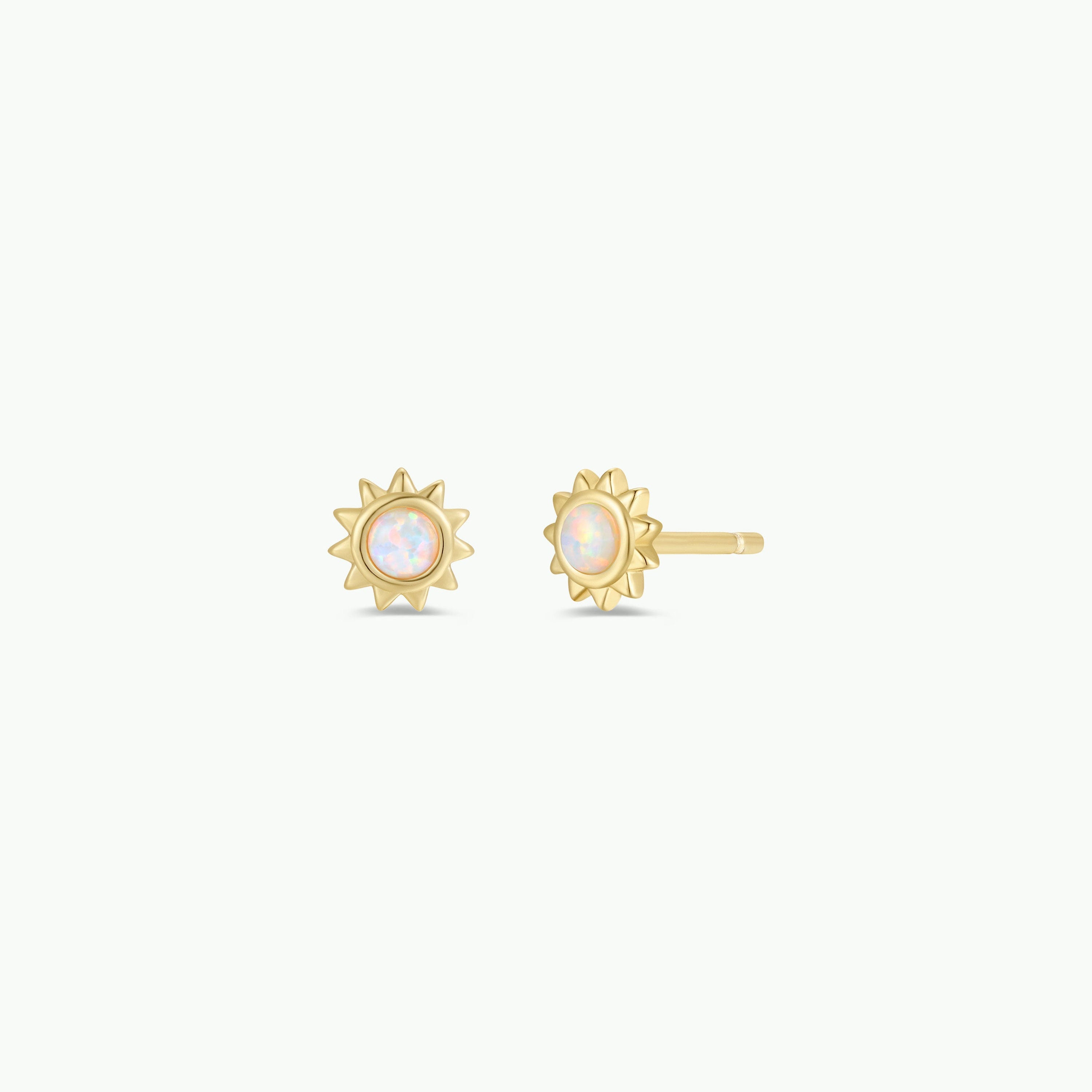 The White Opal Sun Stud features sun-shaped gold studs with round lab-grown white opals at the center, crafted with 18k gold plating and sterling silver posts. Displayed on a plain white background.