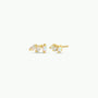 The Offset Trio - White Opal features gold-plated stud earrings, each with three vertically arranged rectangular lab-grown white opal stones in gold prong settings, shown on a plain white background.