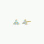 The Trio Cluster Gold Earrings - Fire Opal feature three iridescent lab-grown fire opals in a gold-plated triangular stud design. One earring is upright, the other on its side, both shown against a white background.