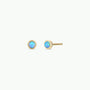 The Simple Stud Earring - Fire Opal features a pair of small 18k gold plated studs, each adorned with a round lab-grown fire opal gemstone, shown on a plain white background.