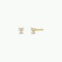 Double Stud Stack: Small gold stud earrings with two vertically arranged clear gemstones—a white baguette CZ stacked over another—set in a minimalist 18k gold-plated design.