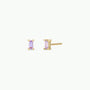 The Lilac Baguette earrings feature rectangular light purple gemstones set in 18k gold plating with sterling silver posts, shown against a plain white background.
