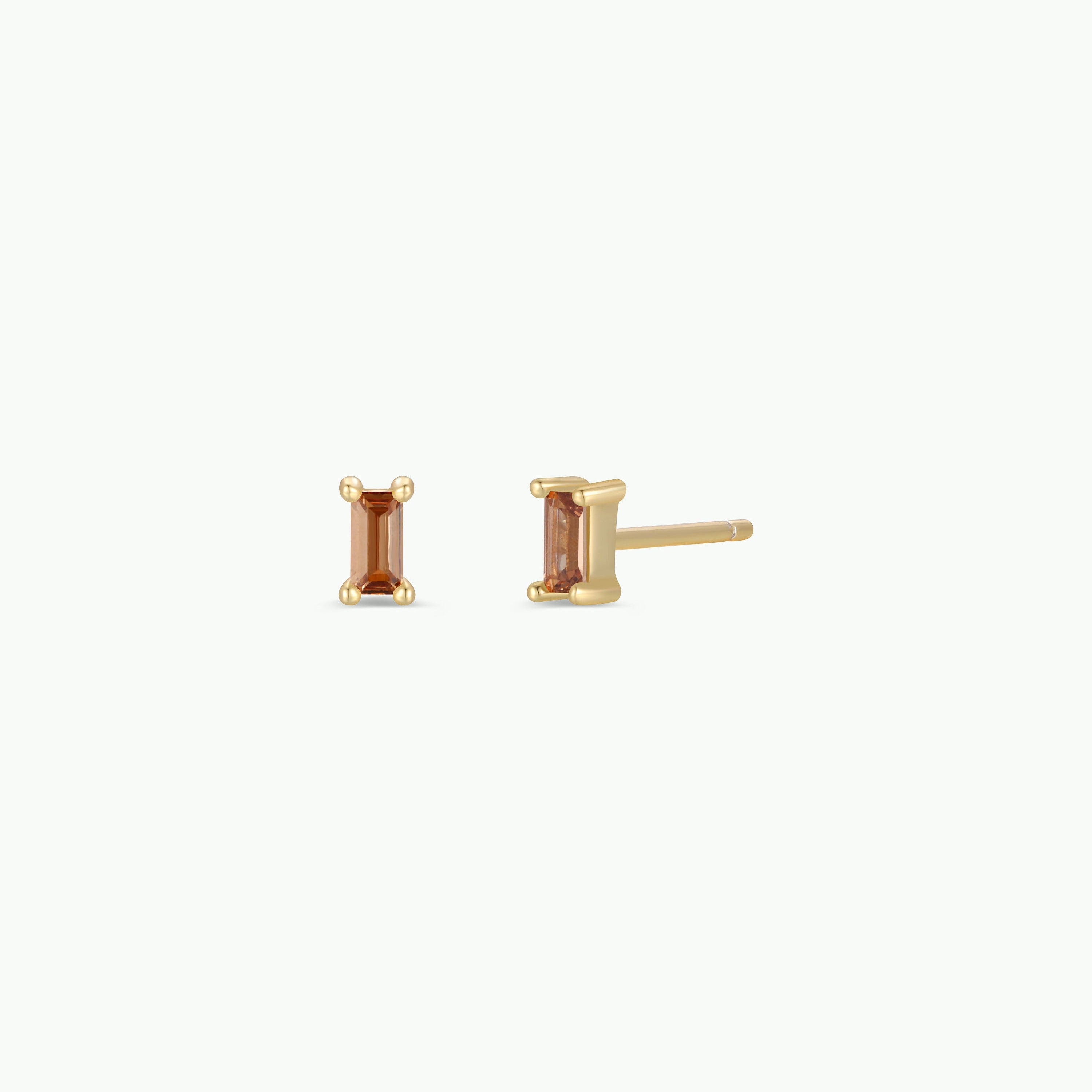 The Coffee Baguette features gold plated stud earrings with rectangular orange gemstones and sterling silver posts, shown on a plain white background.