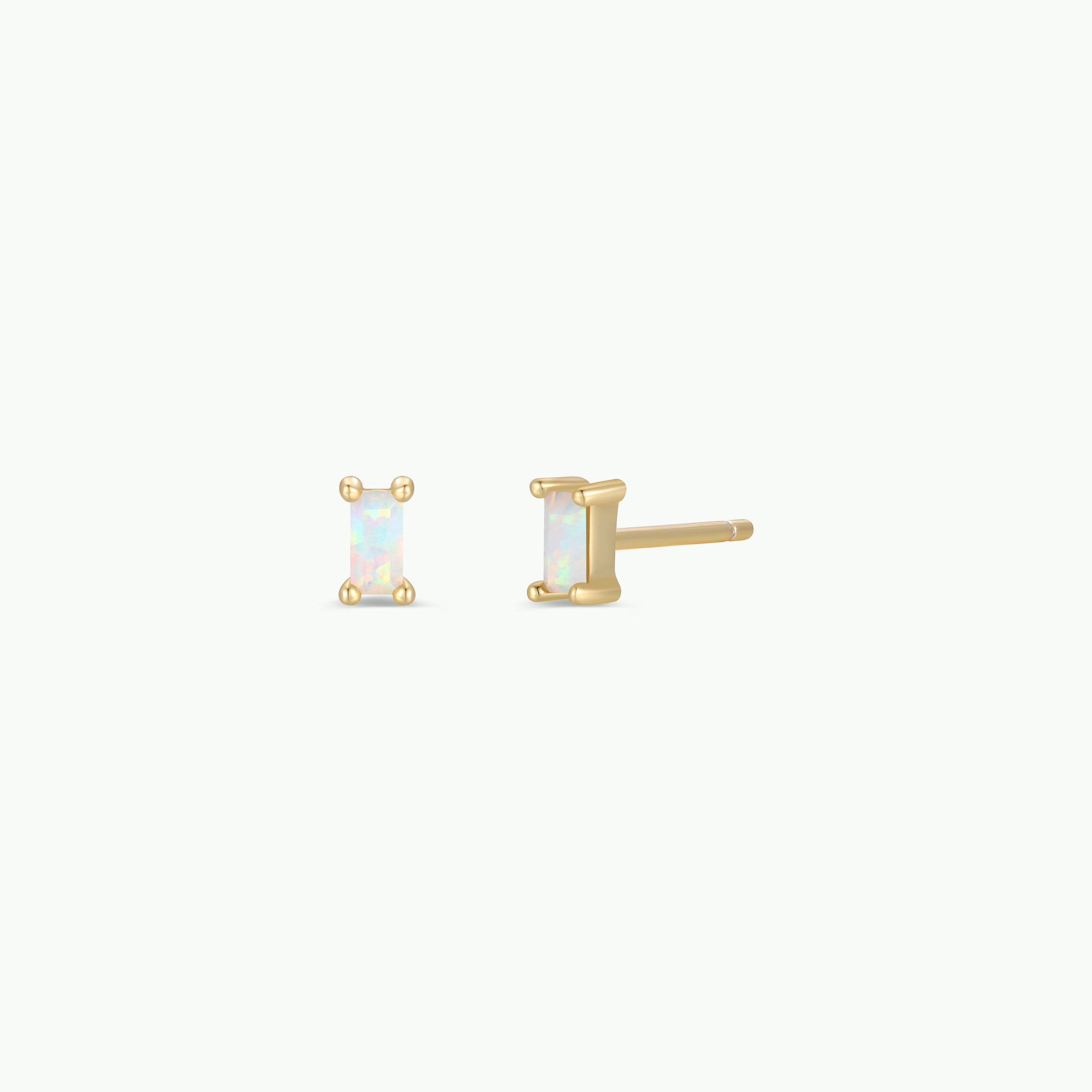 The White Opal Baguette features rectangular lab-grown white opal baguette stud earrings with 18k gold plating, displayed from the front and side on a plain white background.
