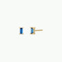 The Sapphire Baguette earrings are gold-plated stud earrings with rectangular blue gemstones, displayed from the front and side on a plain white background.