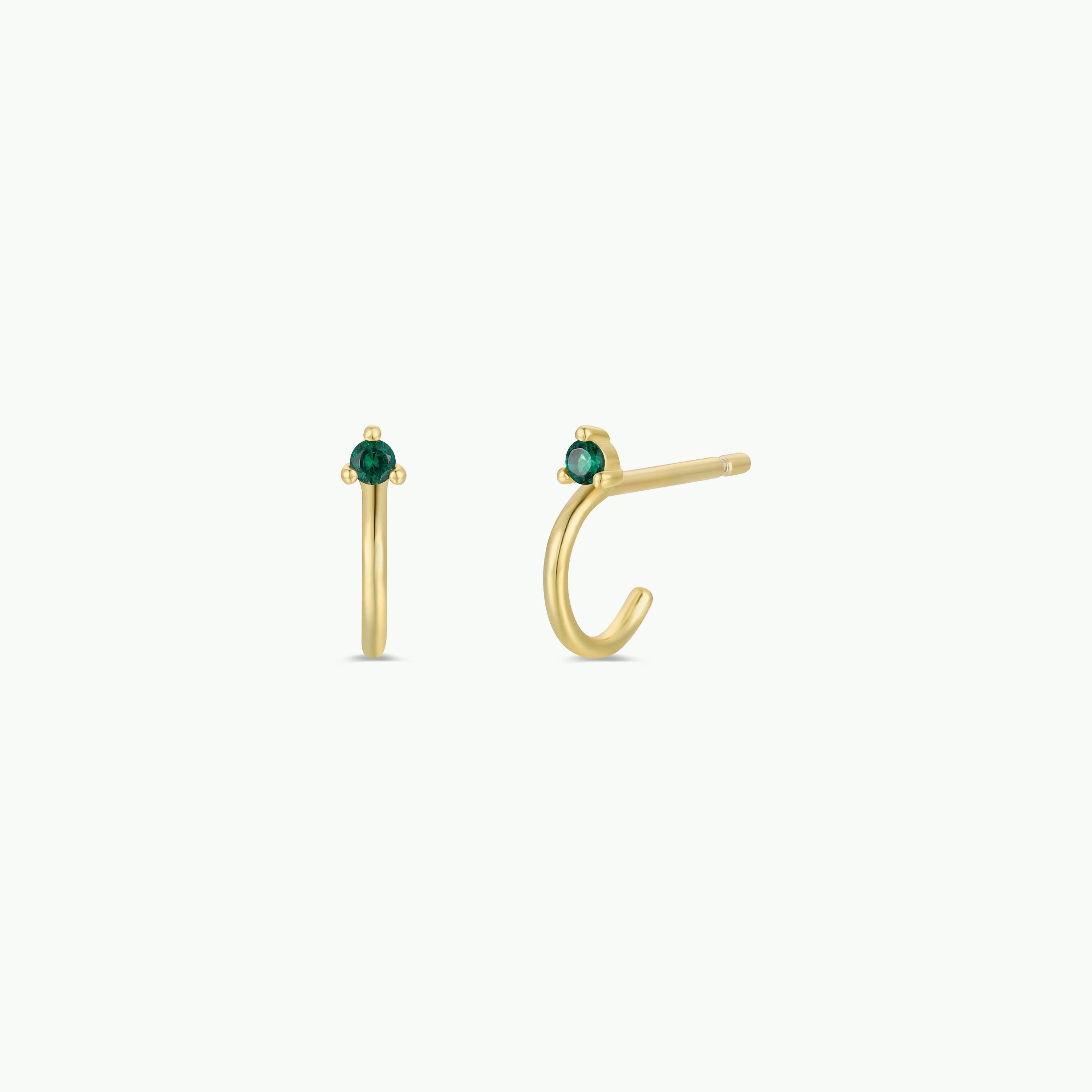 A pair of Open Mini Hoop Earrings - Green Emerald, gold plated with emerald CZ stones, shown from two angles on a plain white background.