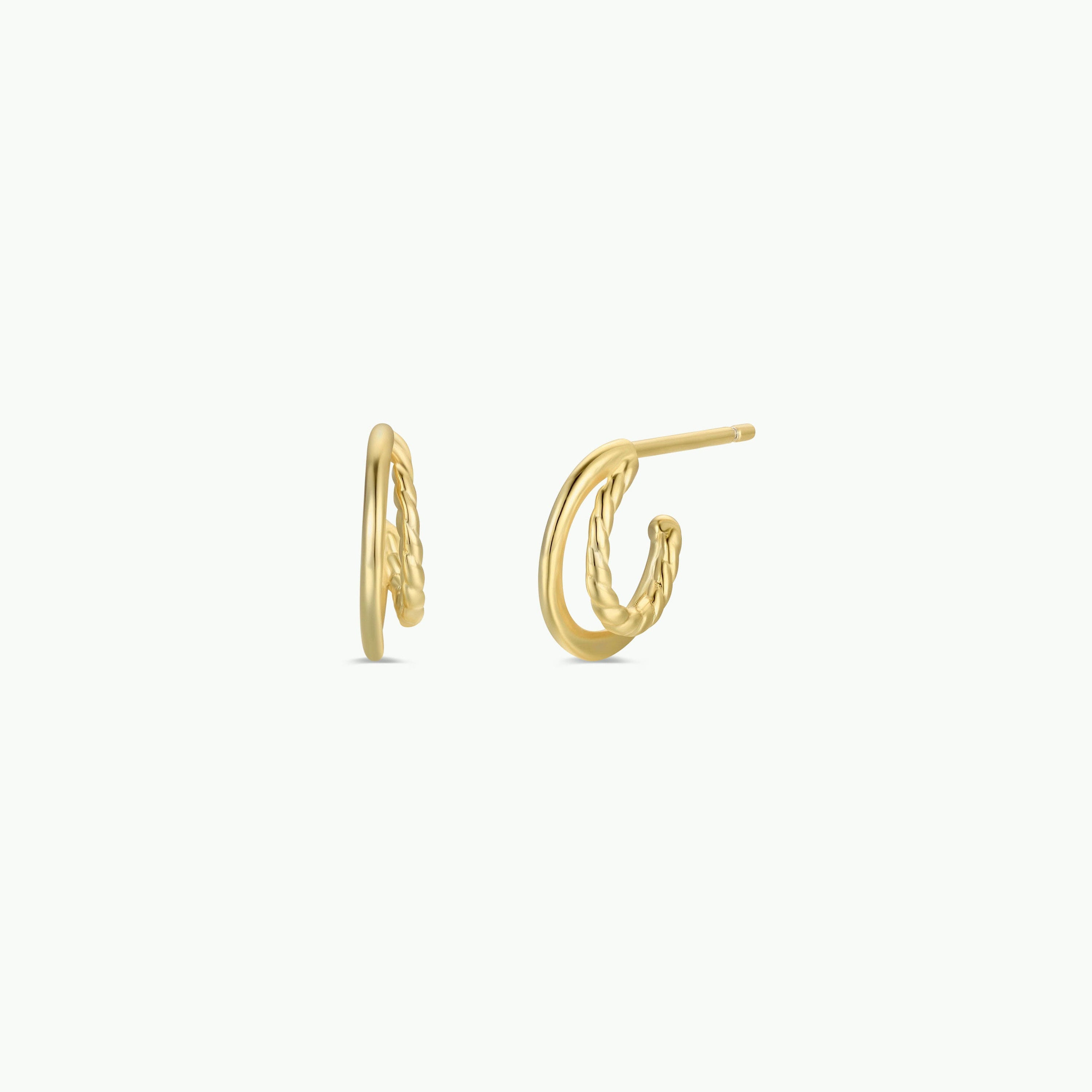 The Double Hoop - Earring is a pair of small gold plated hoops featuring a twisted design on one side, shown against a plain white background.