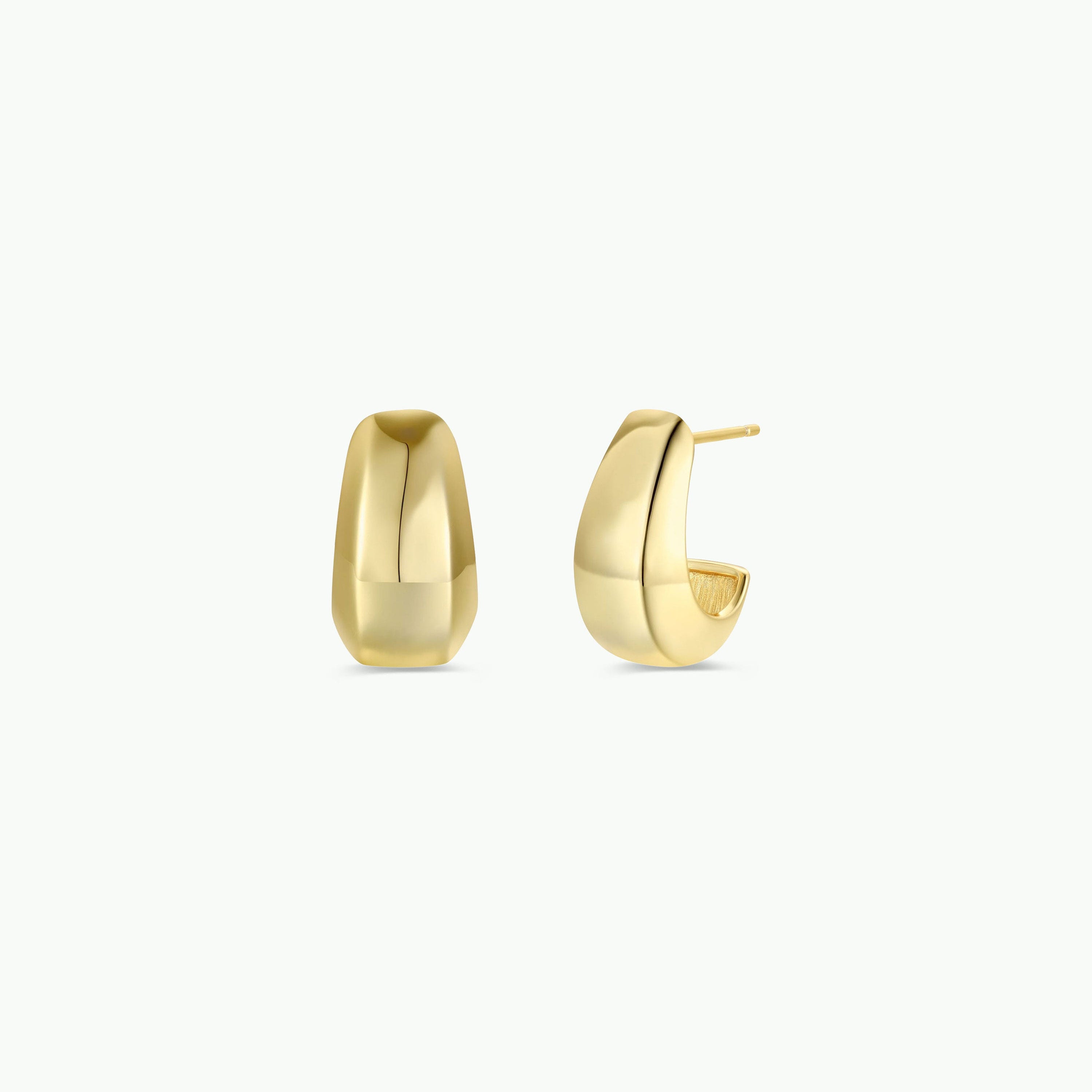 The Bold Drop Earring, a pair of chunky, smooth gold plated hoops, is shown on a plain white background with one earring facing front and the other side-on to highlight their bold statement design.