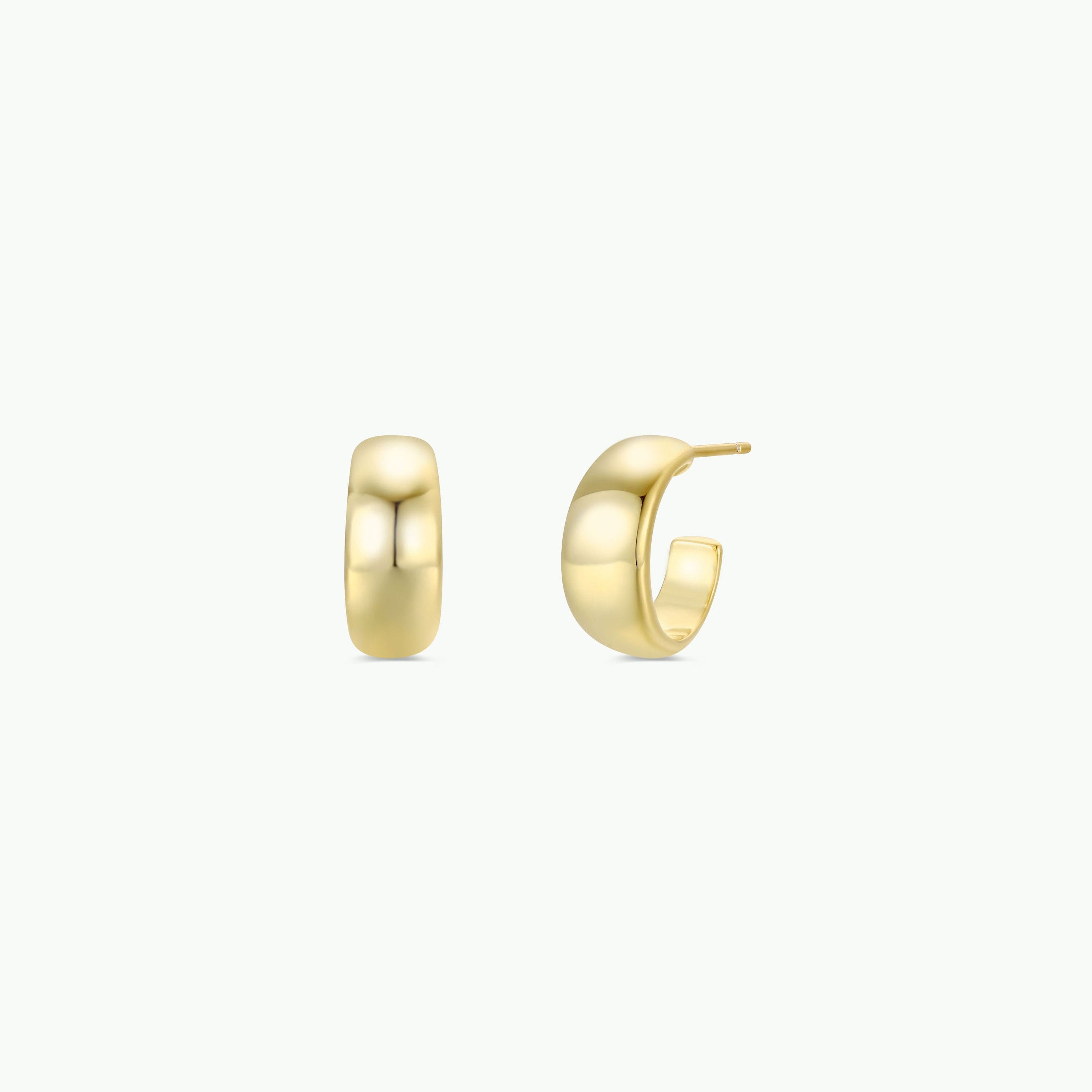The Gold Wide Hoop earrings are small, chunky, and minimalist, shown on a white background—one hoop faces forward and the other sideways to reveal the post. Both feature elegant 18k gold plating.