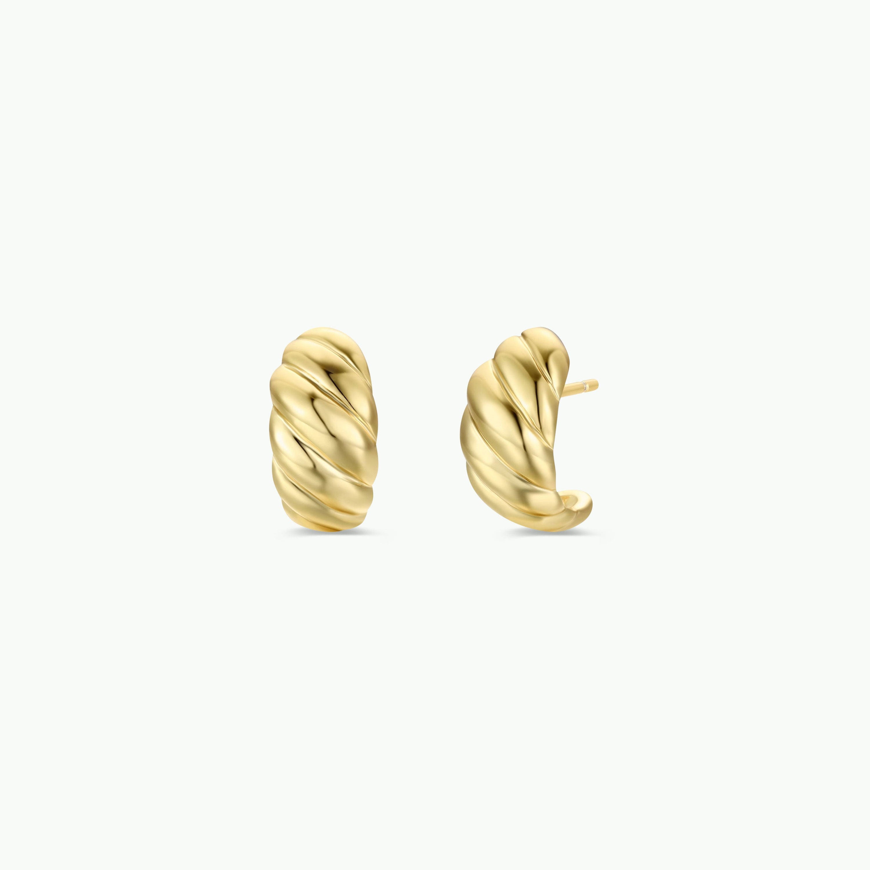The Gold Swirl Hoop earrings, featuring a twisted hoop design and gold plating, are displayed on a plain white background—one facing forward and one angled to show the side and post, offering modern style for any occasion.