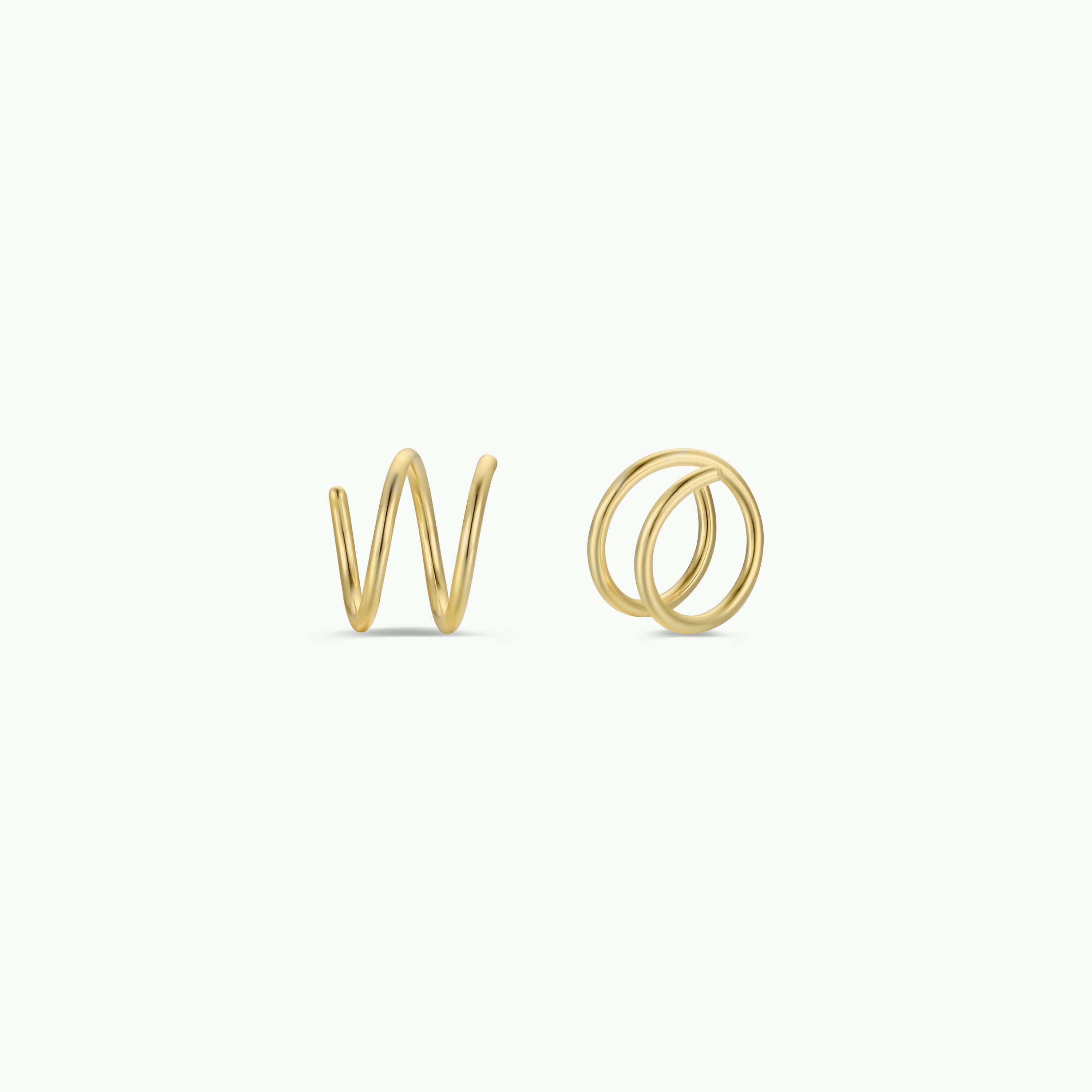 The Minimalist Spiral features two sterling silver rings with 18k gold plating, shaped like the lowercase letters “w” and “o,” displayed on a plain white background.