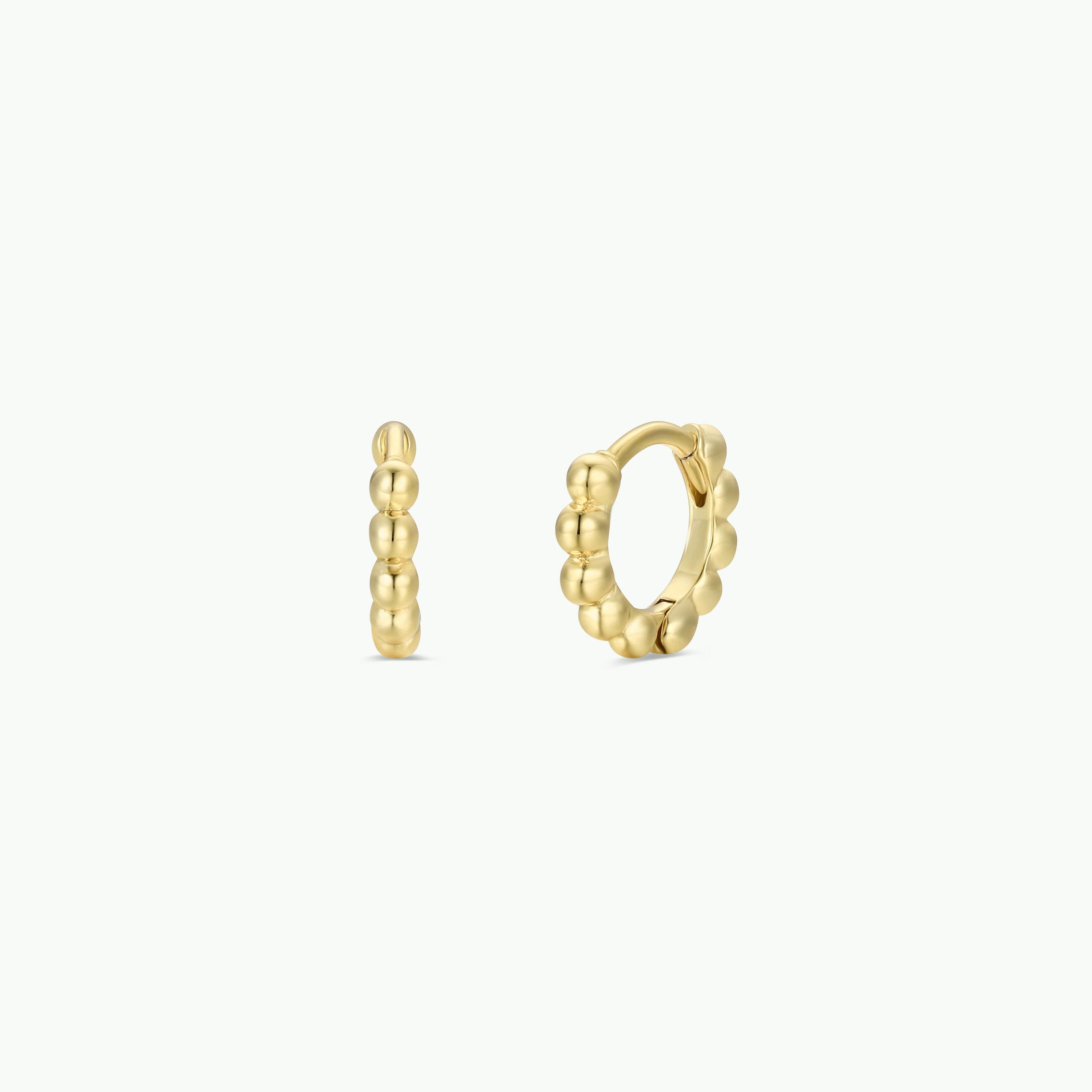 The Tiny Ball Hoop earrings feature a gold plated beaded design with sterling silver posts, displayed on a plain white background—one shown from the side and one from the front.