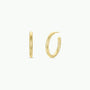 The Gold Everyday Hoop - Medium is displayed on a white background, with one earring facing forward and the other sideways to highlight its thickness and clasp—an ideal pick for lovers of classic, timeless jewelry.