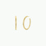 The Gold Everyday Hoop - Large features two simple 18k gold plated earrings on a clean white background, shown from front and side angles to highlight their smooth, minimalist design—a timeless jewelry essential.