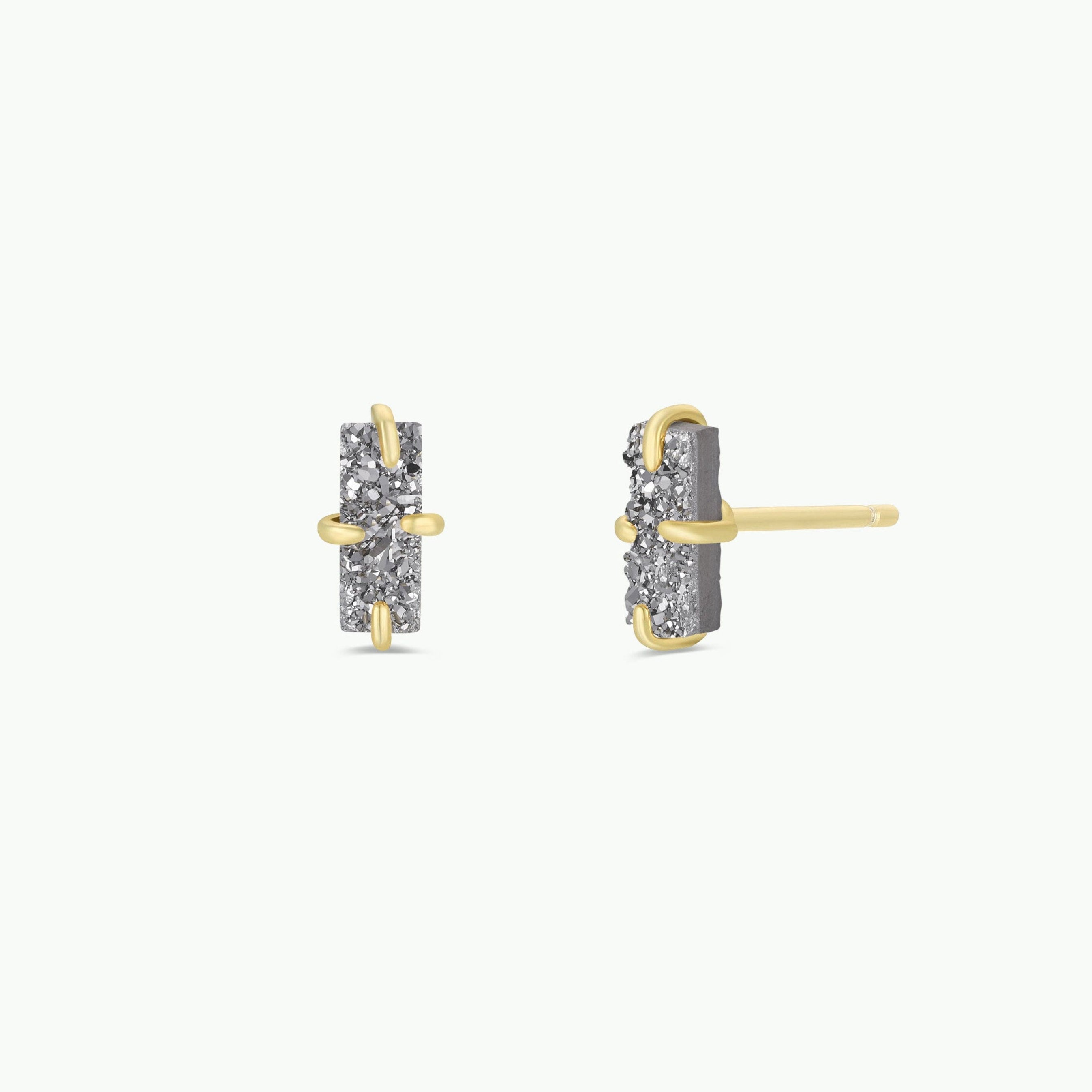 A pair of Silver Bar Druzy stud earrings with vertical rectangular shapes, featuring embedded small stones in a prong setting and 18k gold plating, displayed from the front and side on a plain white background.