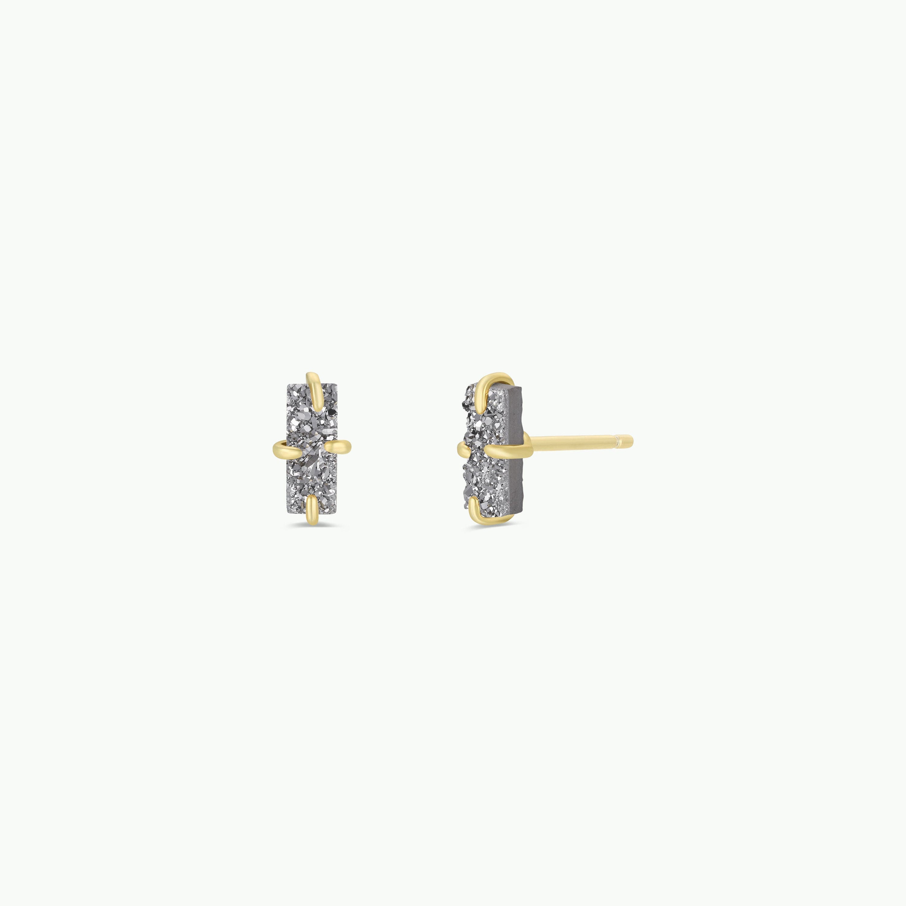 A pair of Silver Bar Druzy stud earrings with vertical rectangular shapes, featuring embedded small stones in a prong setting and 18k gold plating, displayed from the front and side on a plain white background.
