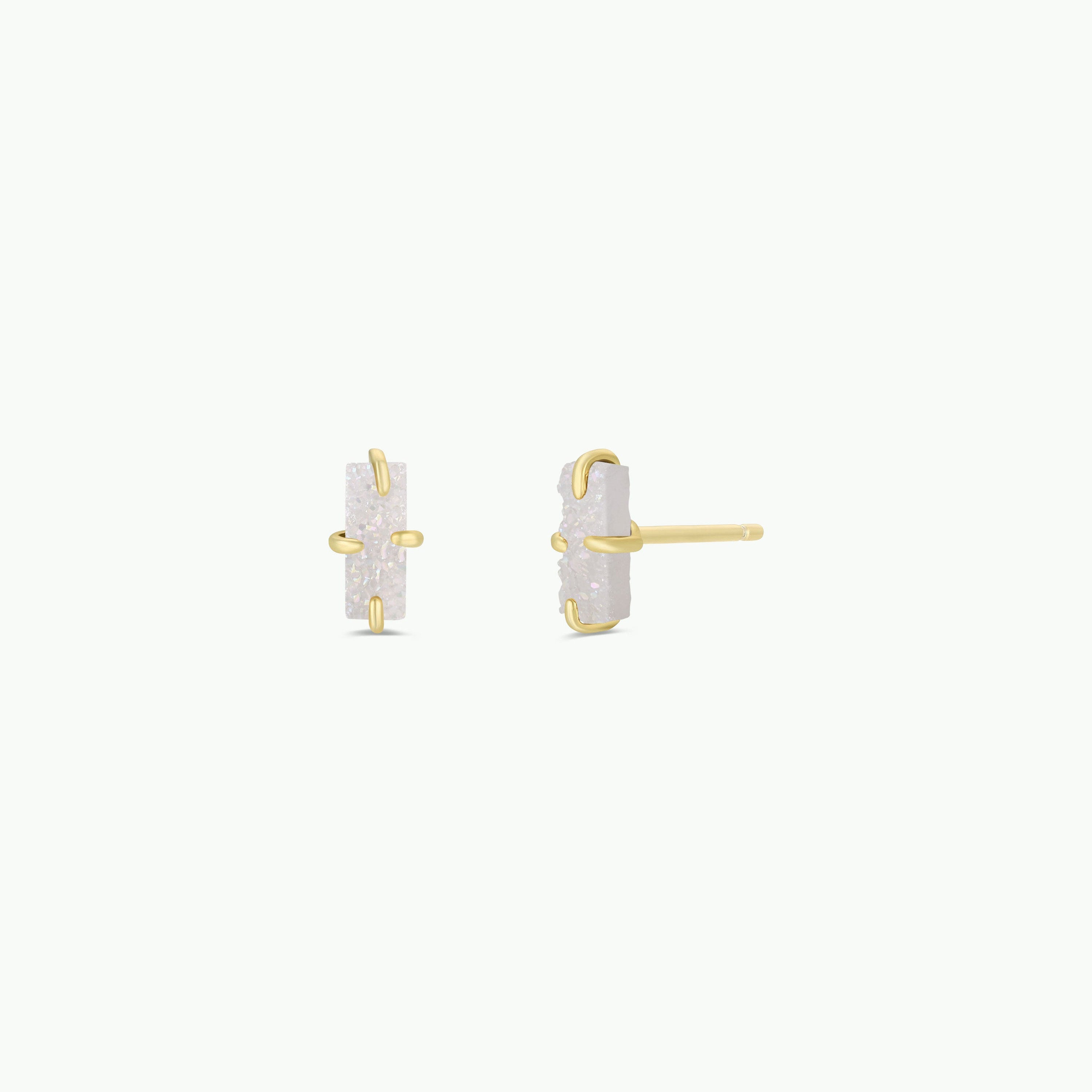 The White Bar Druzy features rectangular stud earrings with white druzy stones set vertically in 18k gold plated prong settings, shown from the front and side on a plain white background.