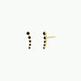 The Black Crawler features gold ear climber earrings with small round black stones in a curved row, crafted from 18k gold plating and sterling silver posts, displayed from the front and side on a white background.