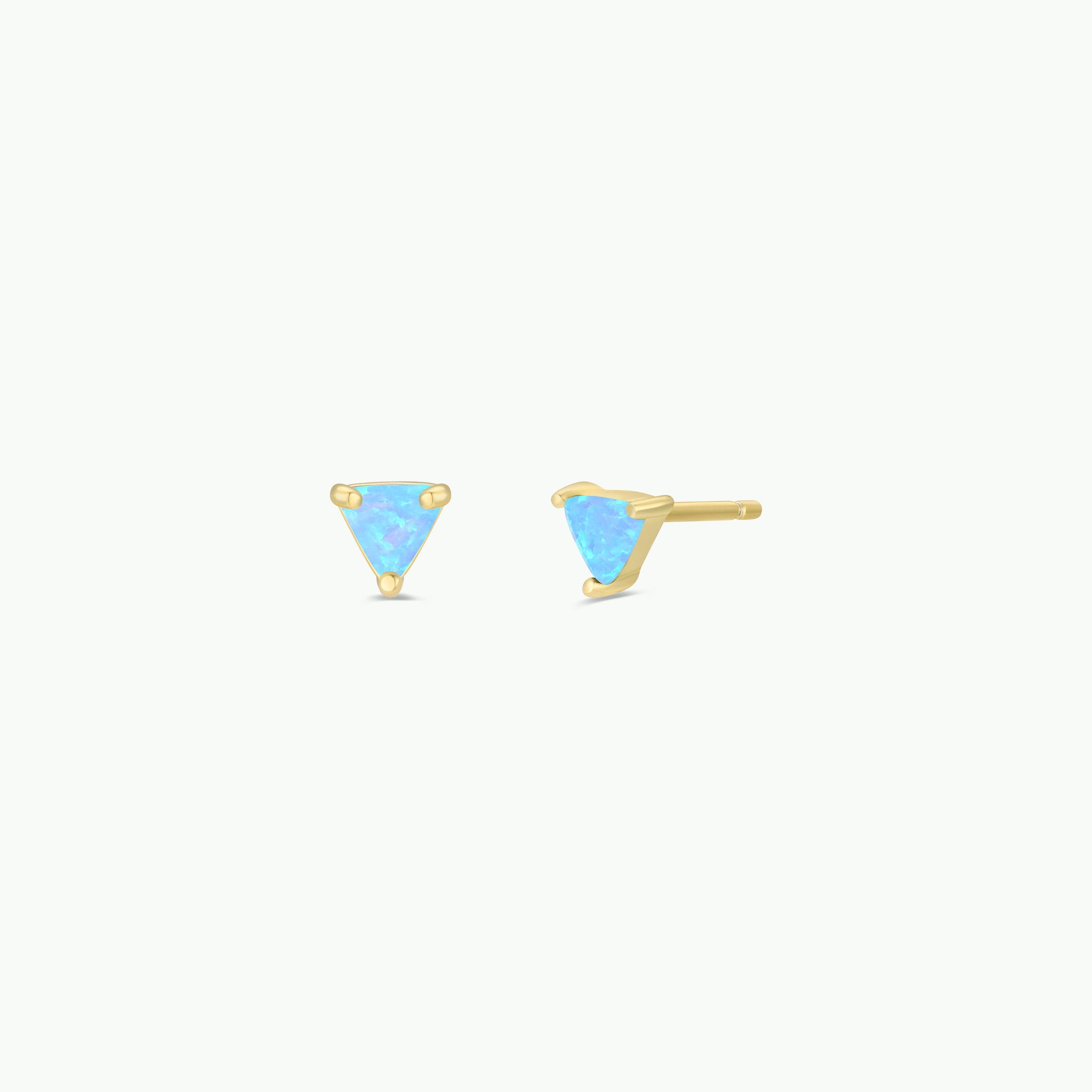 A pair of Fire Opal Mini Energy Gems - Joy studs with small, triangular lab-grown fire opals set in 18k gold plating. One earring is shown front-facing and the other from the side on a plain white background.