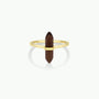 The Smoky Quartz Point Ring showcases a gold band with a vertically set, double-terminated smoky quartz crystal. Displayed on a plain white background, it’s an elegant pick for minimalist jewelry lovers.