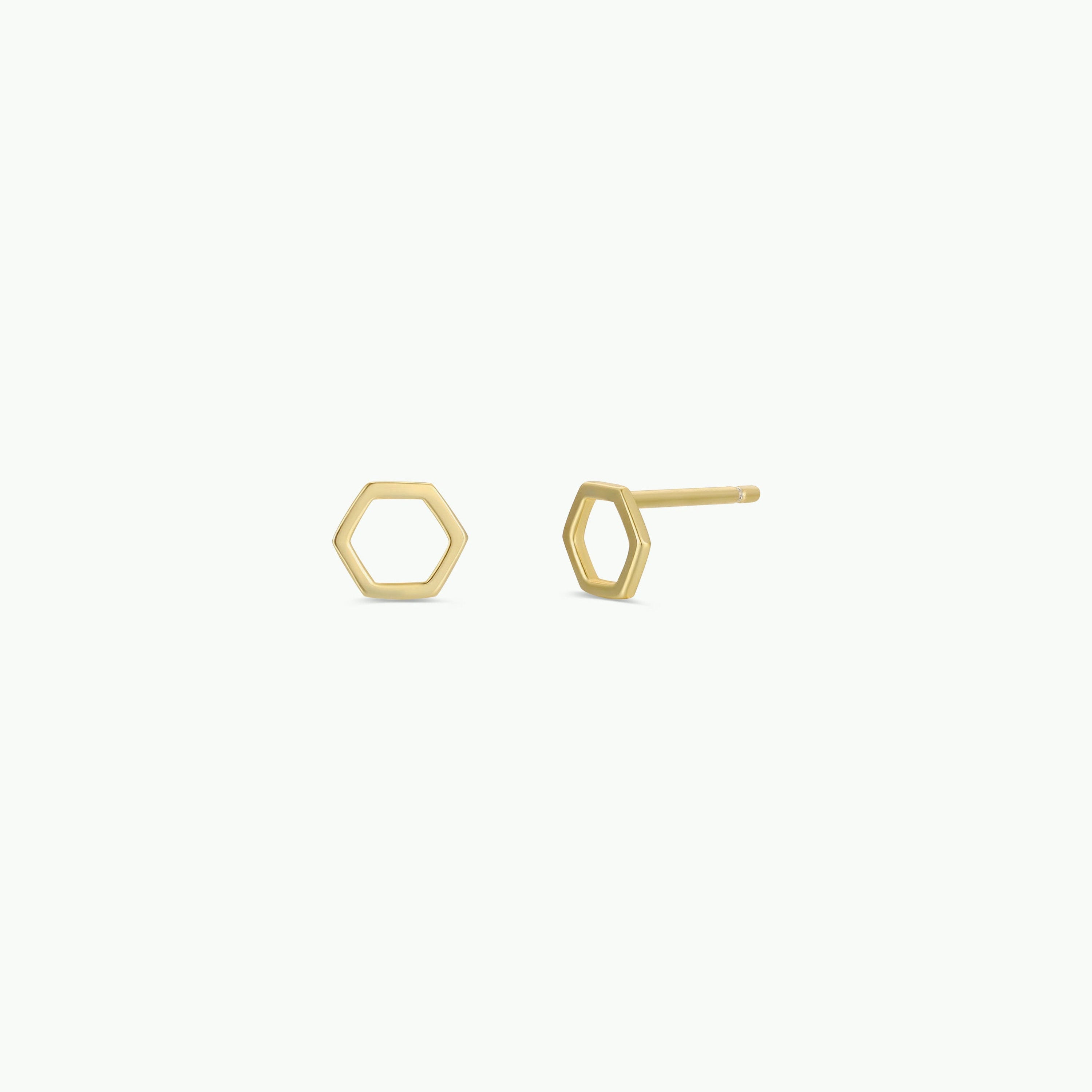 The Minimalist Hexagon earrings are open hexagon-shaped, gold-plated pieces crafted from sterling silver, shown against a plain white background.