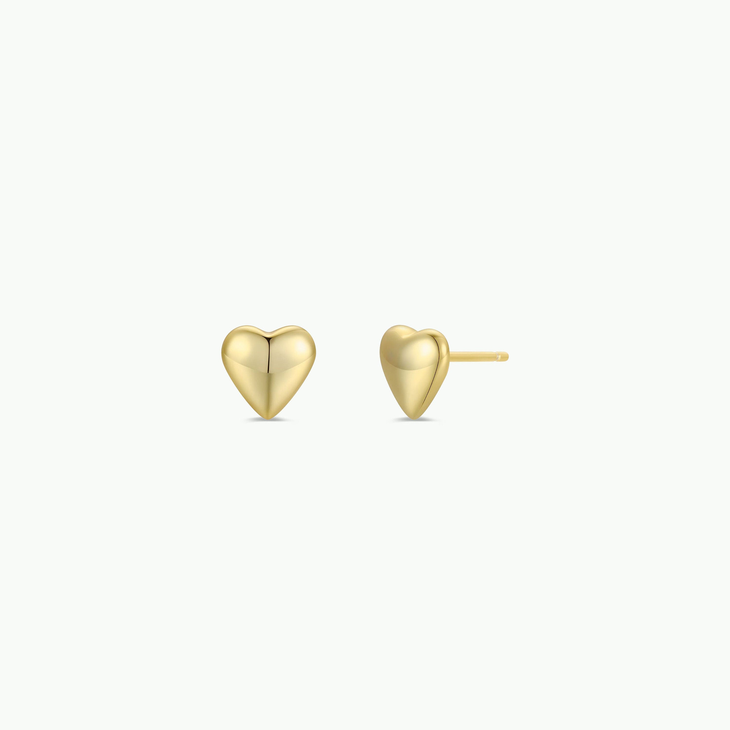 The Puffed Gold Heart Earrings are shown on a white background—one facing forward, the other displaying the post—for an elegant, vintage-inspired touch.