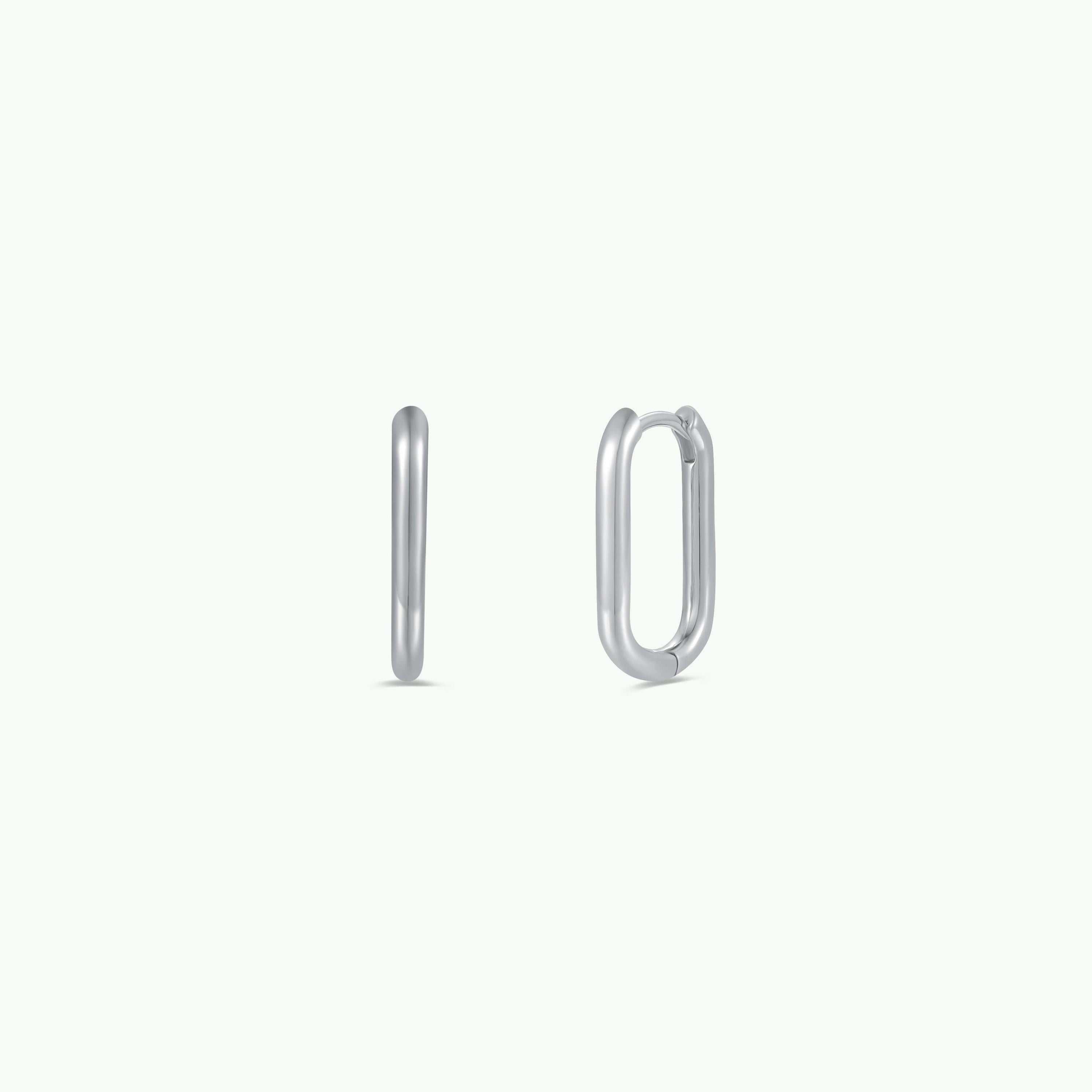 The Silver Rectangle Hoop - Large features two minimalist sterling silver earrings in a rectangular hoop design, displayed on a plain white background from front and side views.
