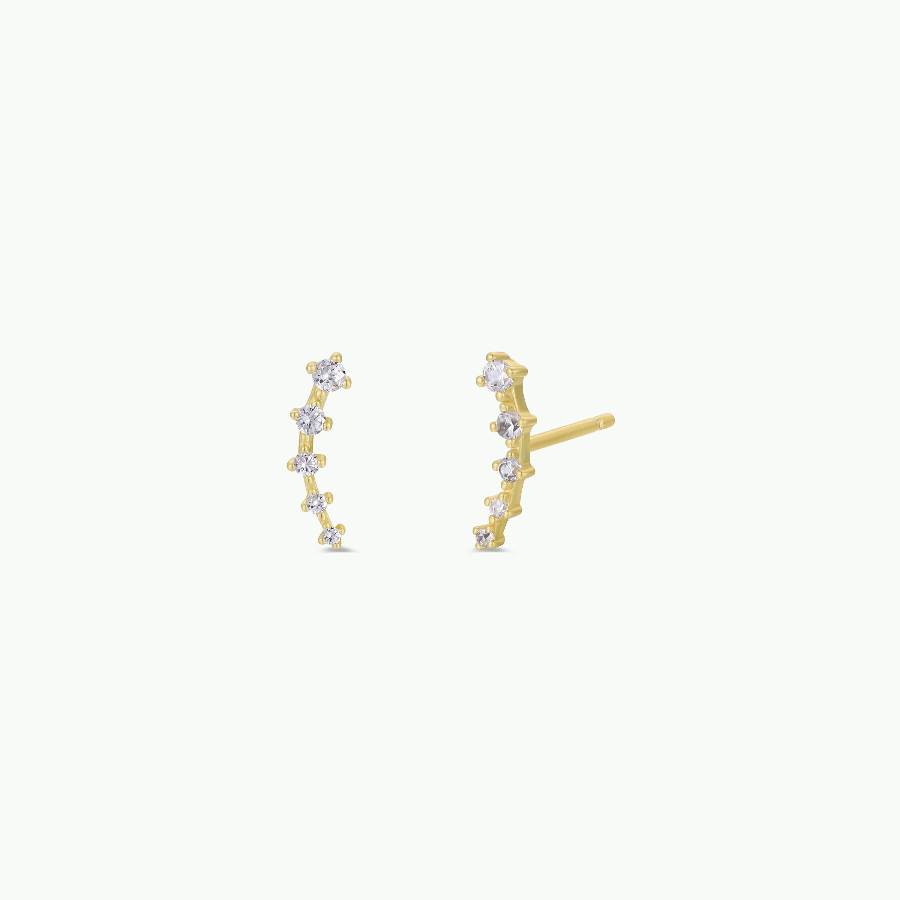The White Crawler features a pair of curved 18k gold-plated stud earrings, each embellished with a row of small round cubic zirconia in a gentle arc, shown on a plain white background.