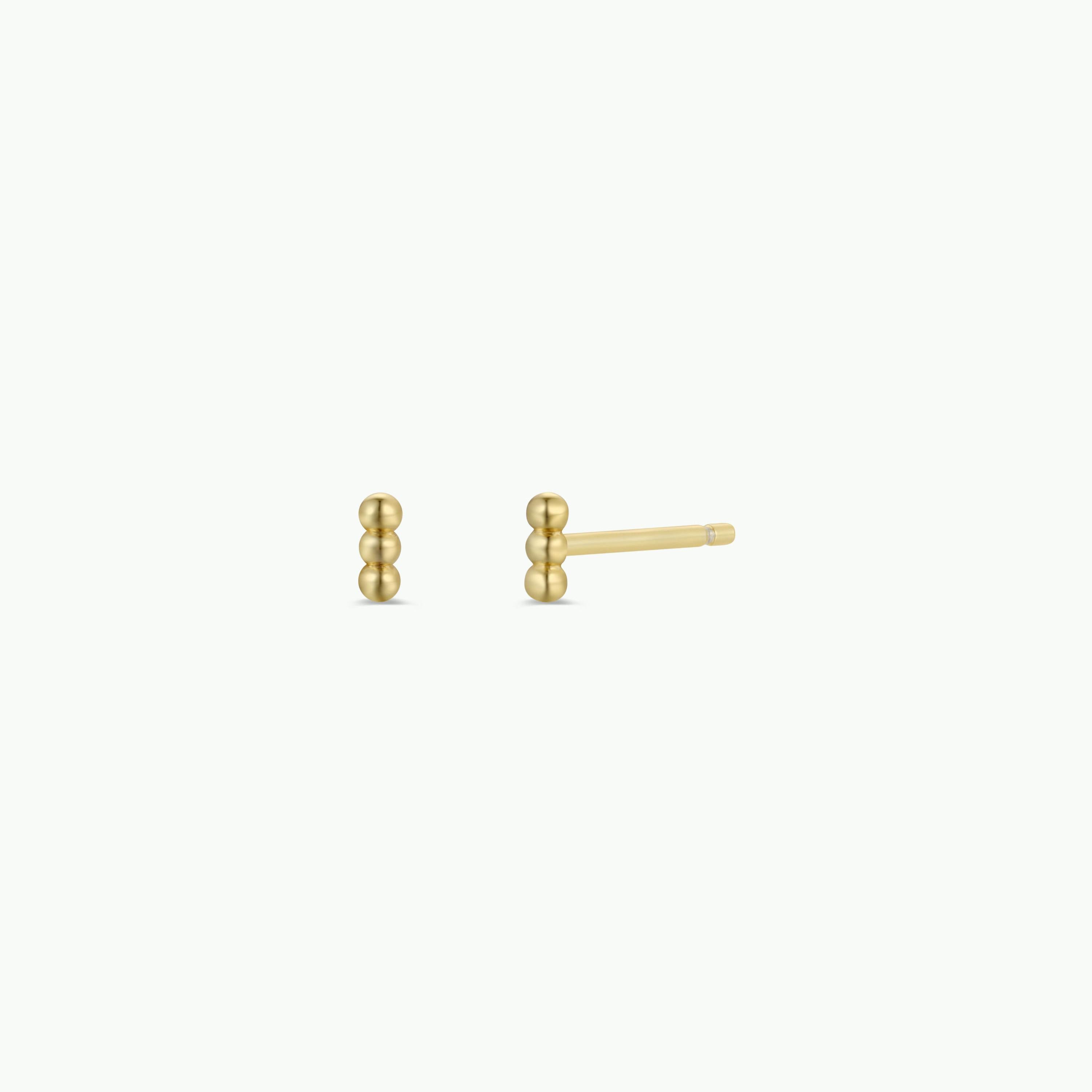 Petite 3 Ball Gold Earrings: minimalist studs with 18K gold plating, each earring featuring three connected beads. Pictured on a plain white background—one earring is front-facing, the other shown from the side.