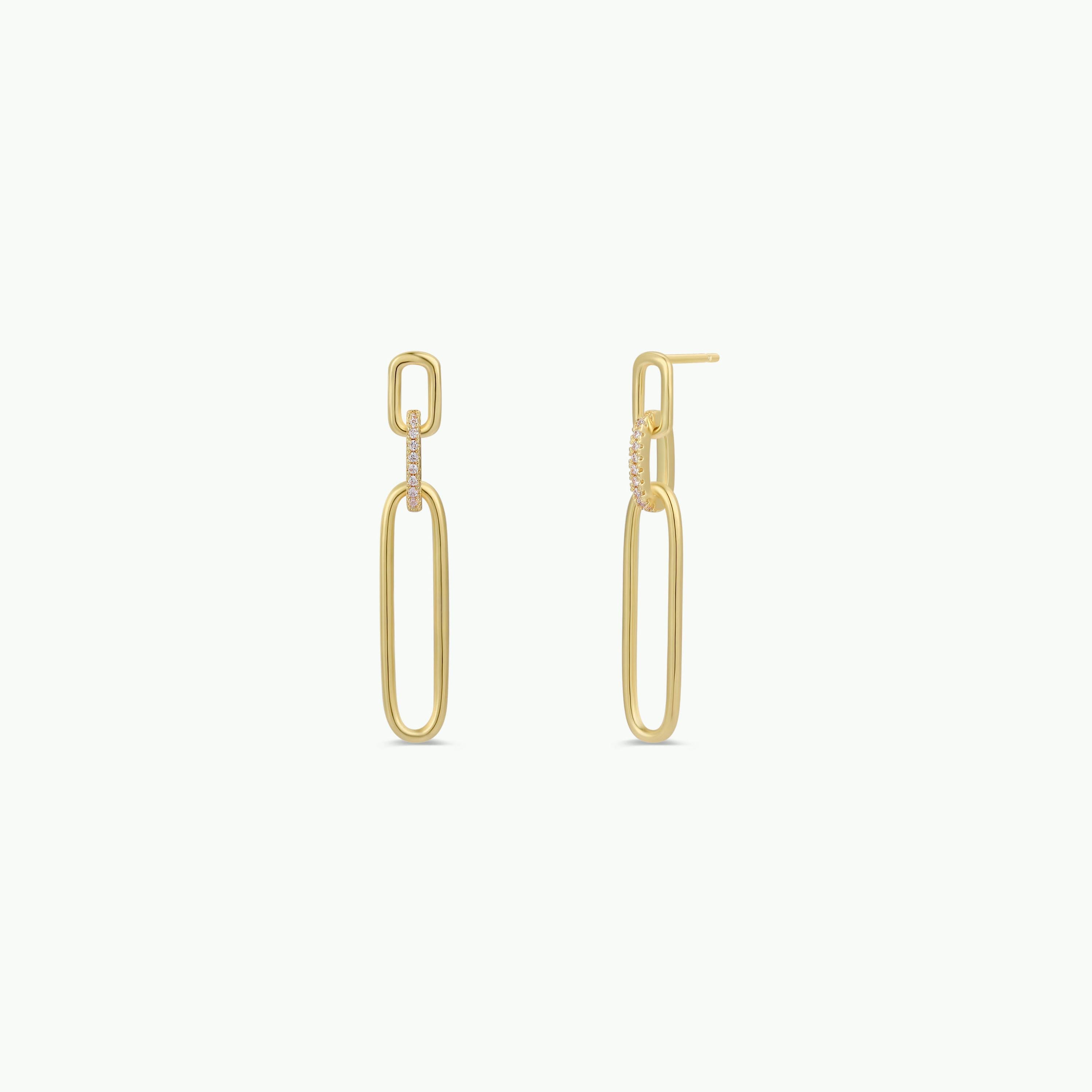 The Pave Link Drop - Earring features two elongated, linked ovals with white pave stones on the upper link, finished in 18k gold plating. These minimalist, modern earrings are shown against a white background.