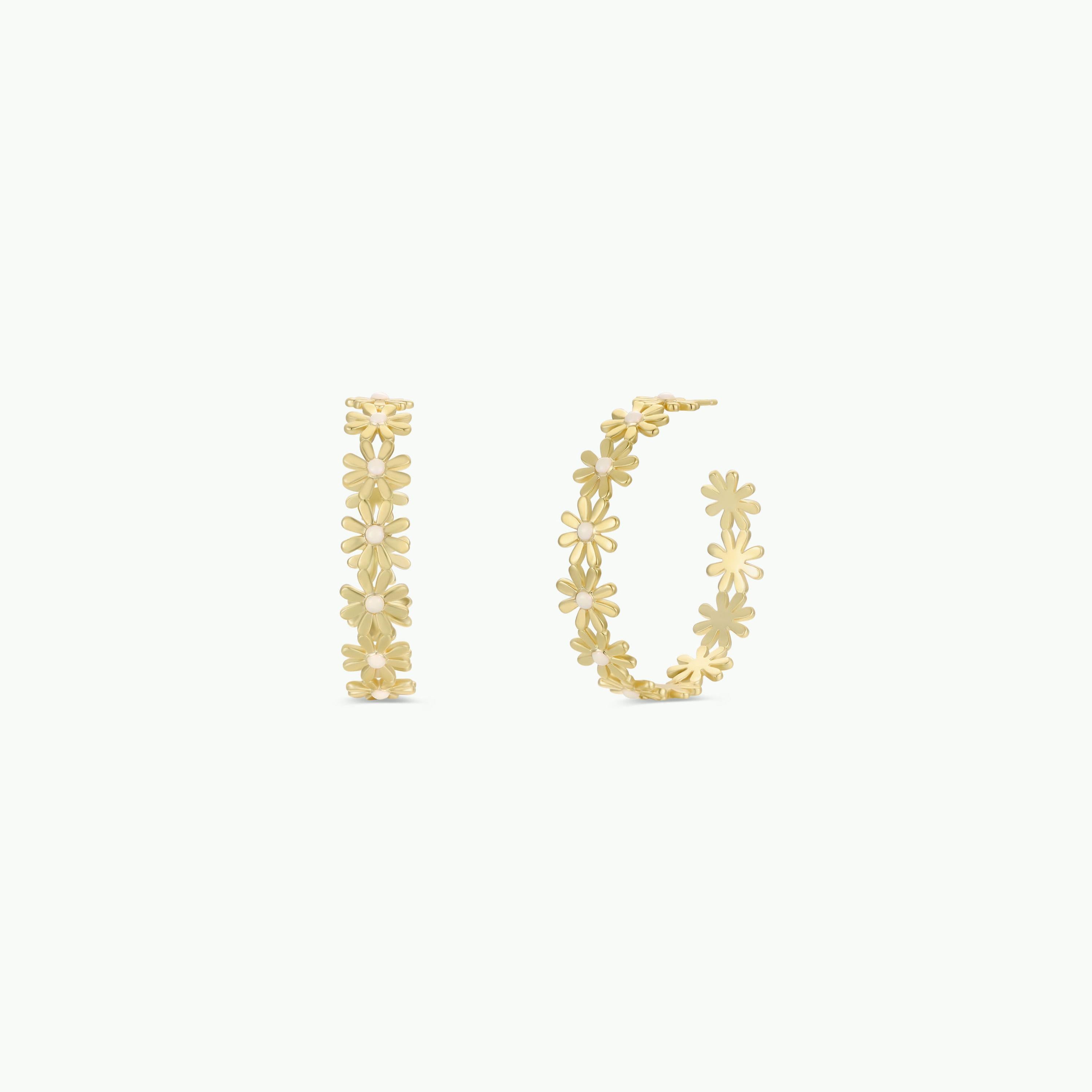 The Daisy Chain Earrings - Enamel and Gold are gold hoop earrings adorned with small daisy designs, displayed from front and side views on a white background.