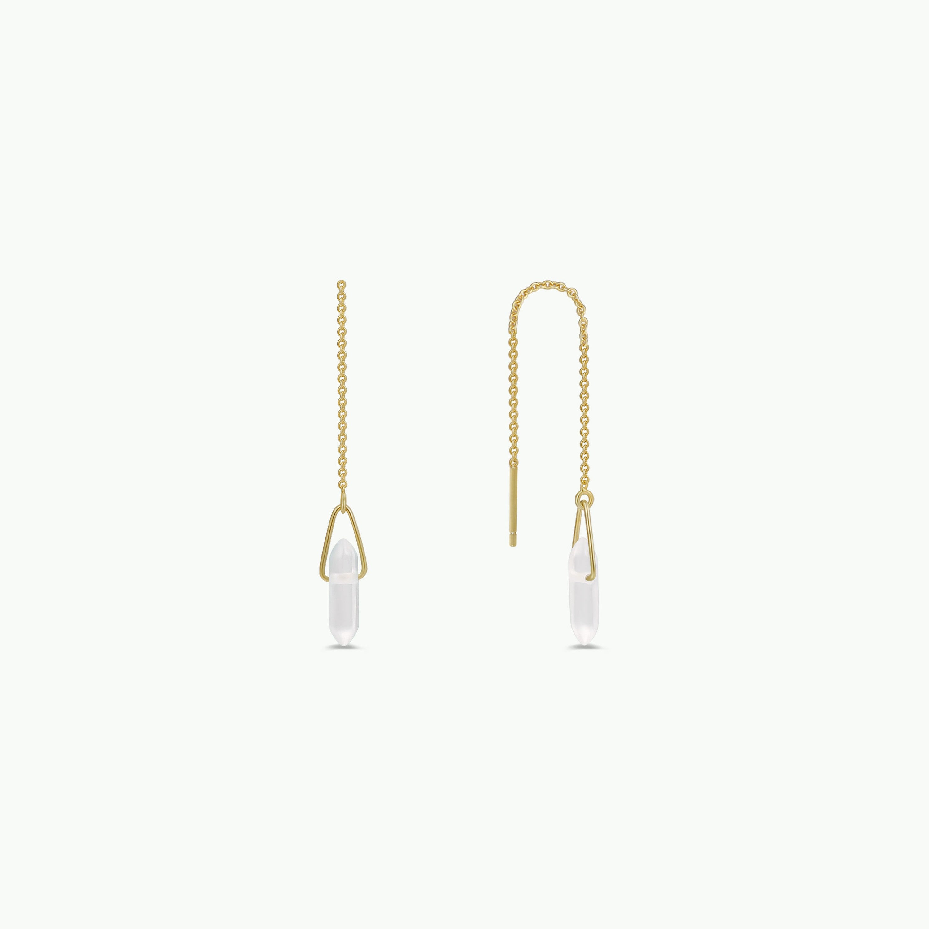 The JaxKelly Gemstone Threader - Clear Quartz features delicate gold-plated threader earrings with a thin chain and clear quartz crystal pendants, elegantly displayed on a plain white background.