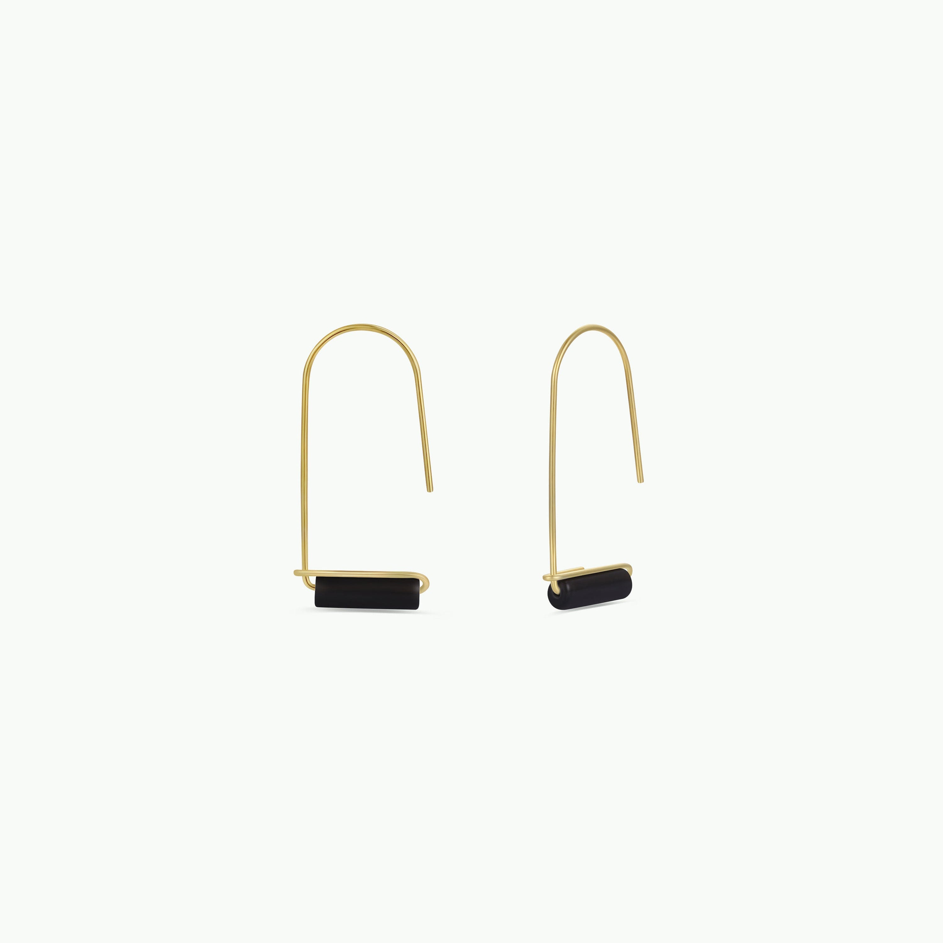 The Black Onyx Gemstone Drop - Focus earrings feature minimalist gold-plated curved wires with small horizontal black onyx bars, set against a plain white background for an elegant look.