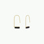 The Black Onyx Gemstone Drop - Focus earrings feature minimalist gold-plated curved wires with small horizontal black onyx bars, set against a plain white background for an elegant look.
