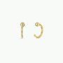 Gold Sphere Huggie: Minimalist 18k gold-plated hoop earrings featuring a small gold ball accent. One earring is displayed front-facing, the other from the side, both set against a plain white background.