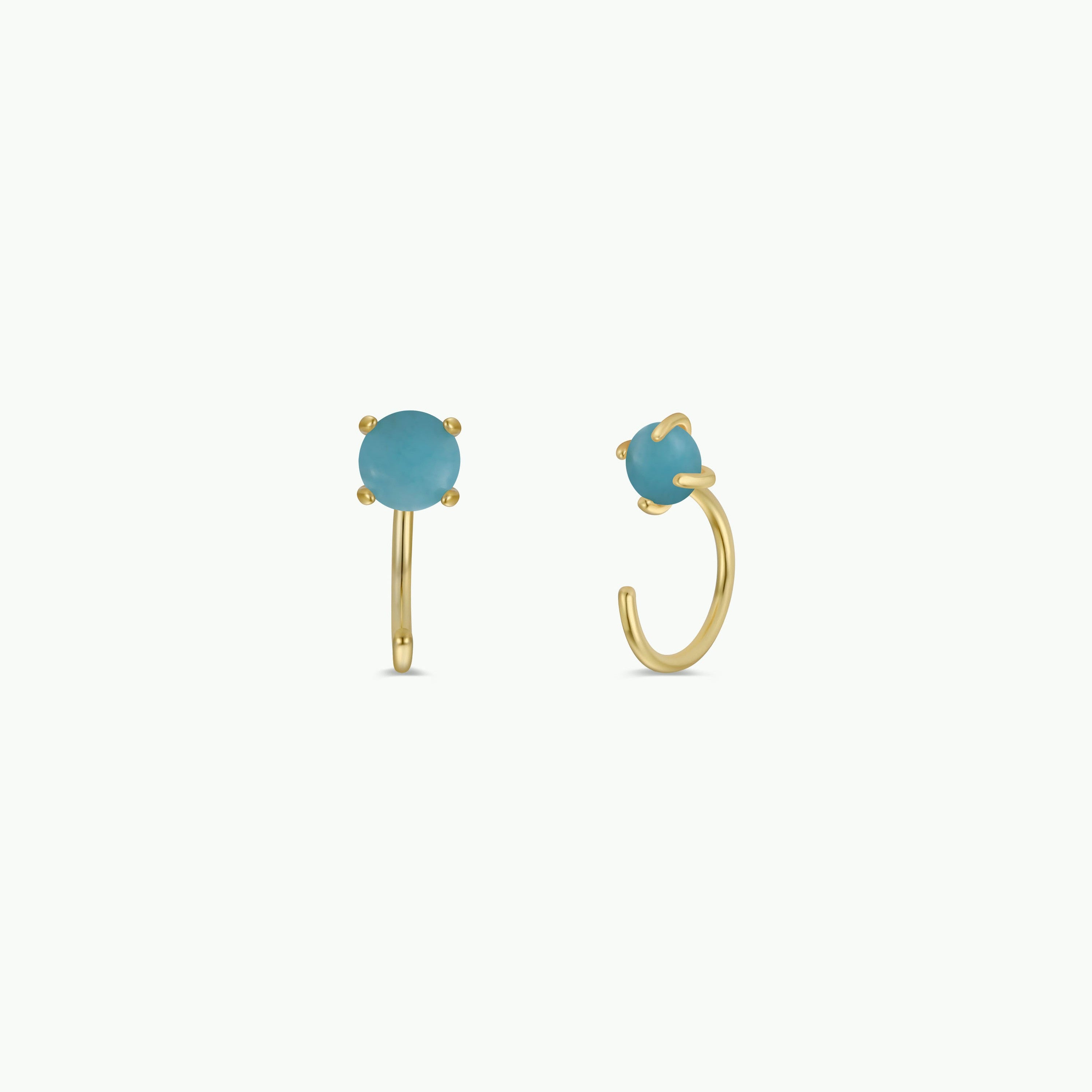 The Amazonite Huggie features gold huggie earrings with round turquoise stones set in four-prong settings, shown on a plain white background.