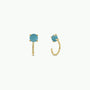 The Amazonite Huggie features gold huggie earrings with round turquoise stones set in four-prong settings, shown on a plain white background.