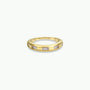 The Inset Baguette Ring features evenly spaced rectangular gemstones set around a gold band, ideal for stacking and shown on a plain white background.