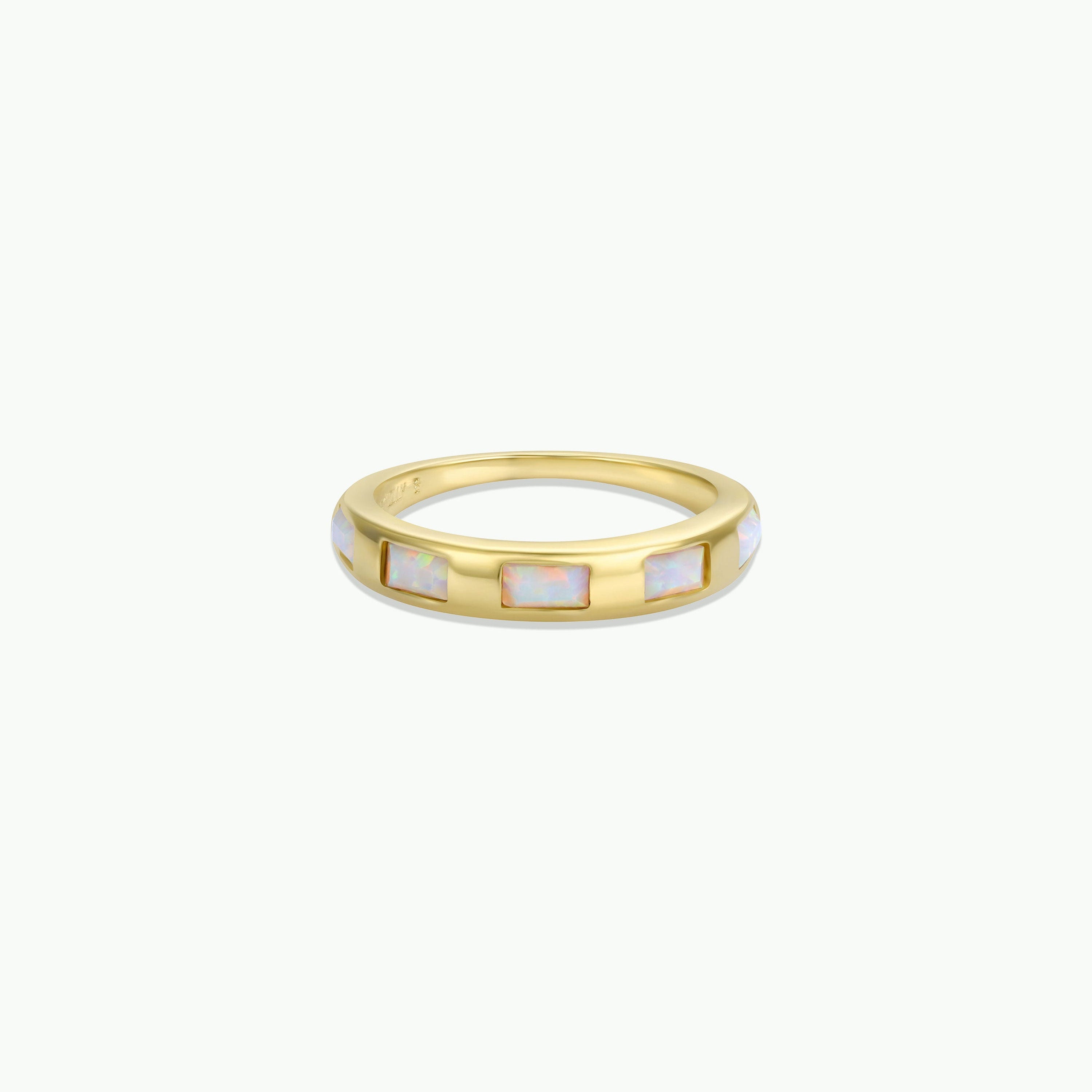 The White Opal Inset Baguette features five lab-grown white opals set evenly around an 18k gold plated band, shown on a plain white background.