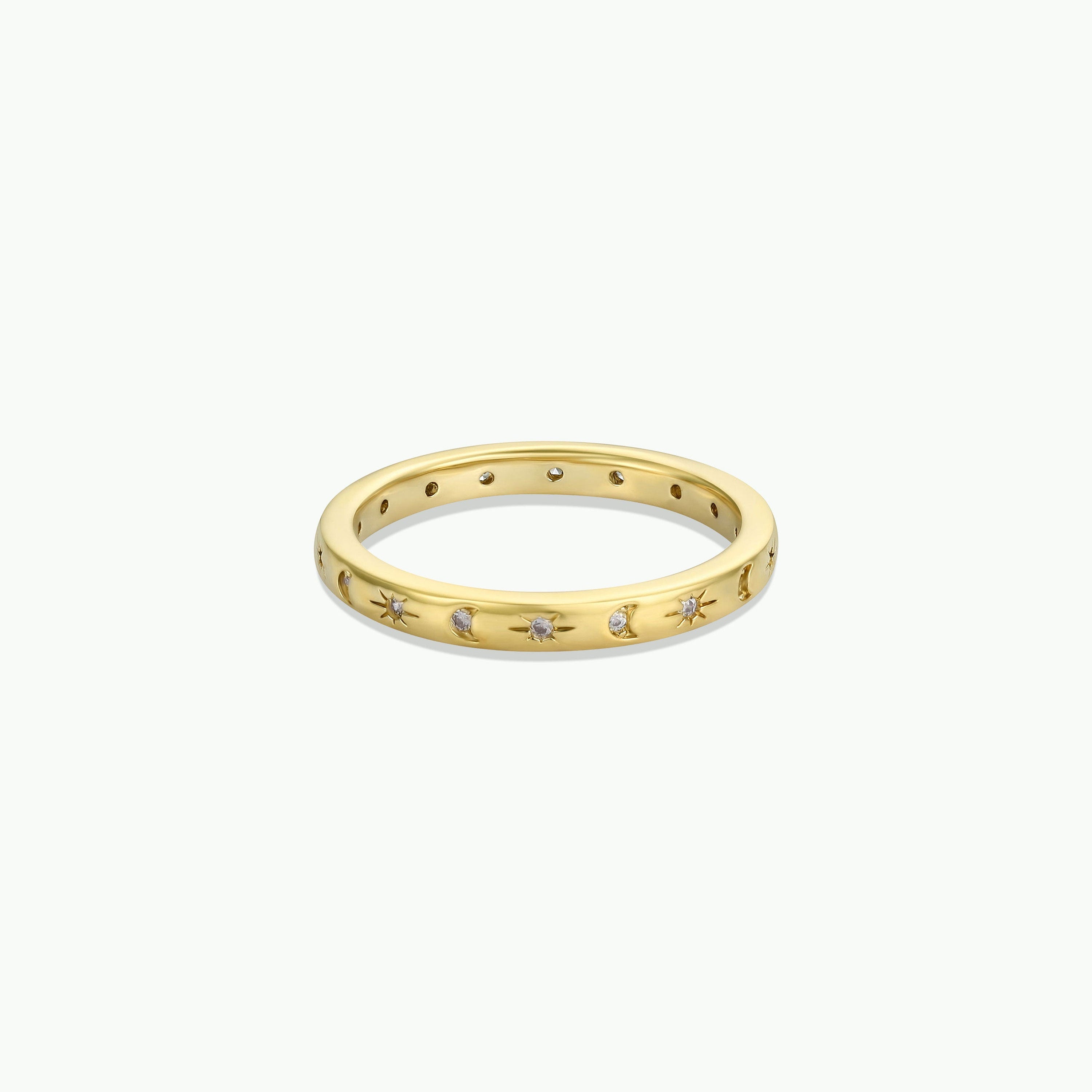 The Celestial Ring is a slim cubic zirconia band with star-shaped engravings, each holding a tiny gemstone, shown against a plain white background.