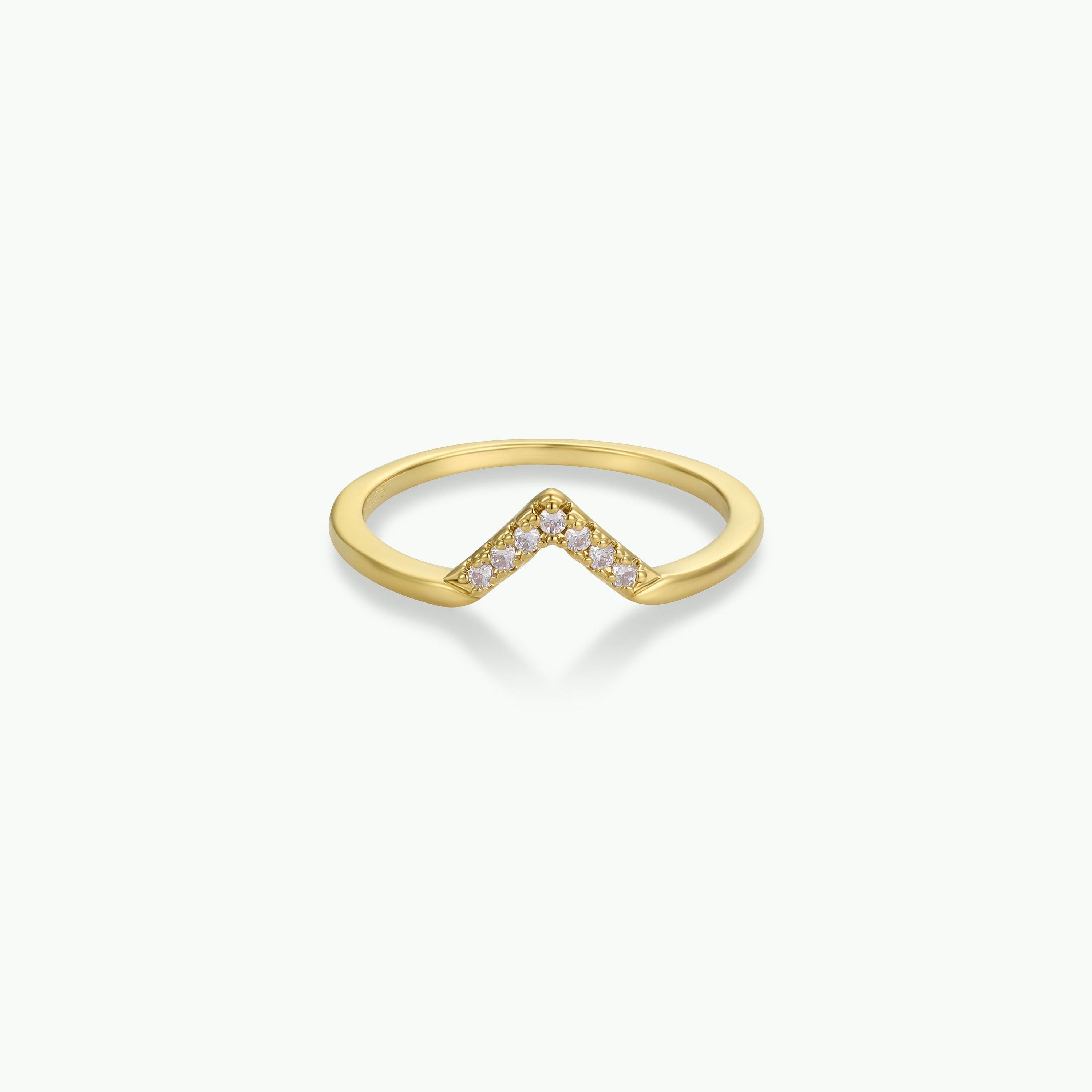 The Lambda Ring is a gold-plated, v-shaped ring adorned with small white cubic zirconia gemstones along the front, shown on a plain white background.