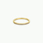 The Half Pavé Ring is a minimalist gold-plated band with a row of sparkling cubic zirconia set along the top, shown against a plain white background.