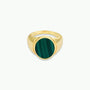 The Malachite Signet Ring features a round, polished malachite stone with natural dark green stripes set at the center, shown on a plain white background.