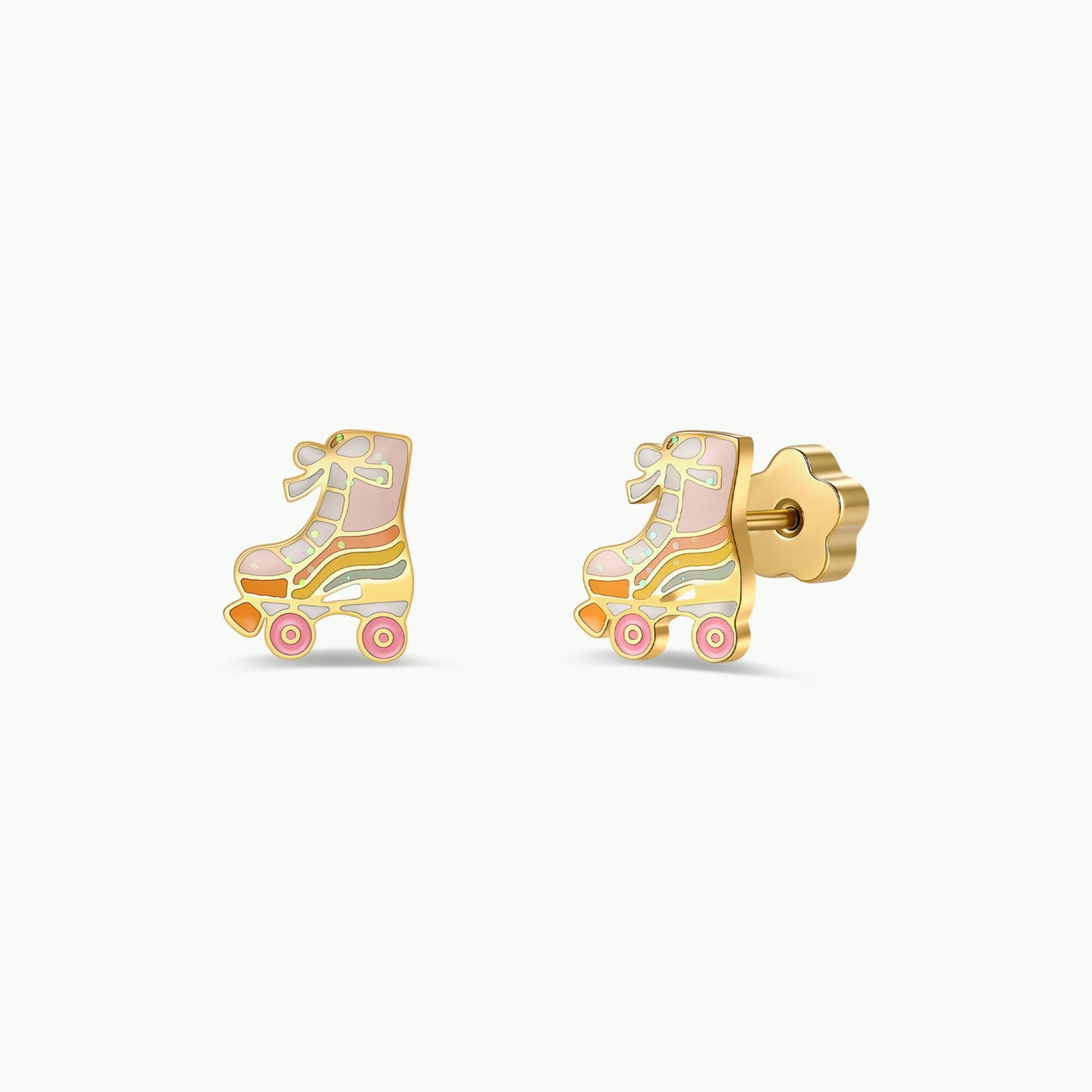 Introducing the Roller Skate Enamel Flat Back Kids Earrings by JaxKelly—a pair of playful gold-tone stud earrings shaped like roller skates. Crafted from surgical-grade stainless steel, these hypoallergenic earrings feature pastel pink, yellow, and white enamel details and are finished with secure butterfly backings, making them an ideal choice for kids.